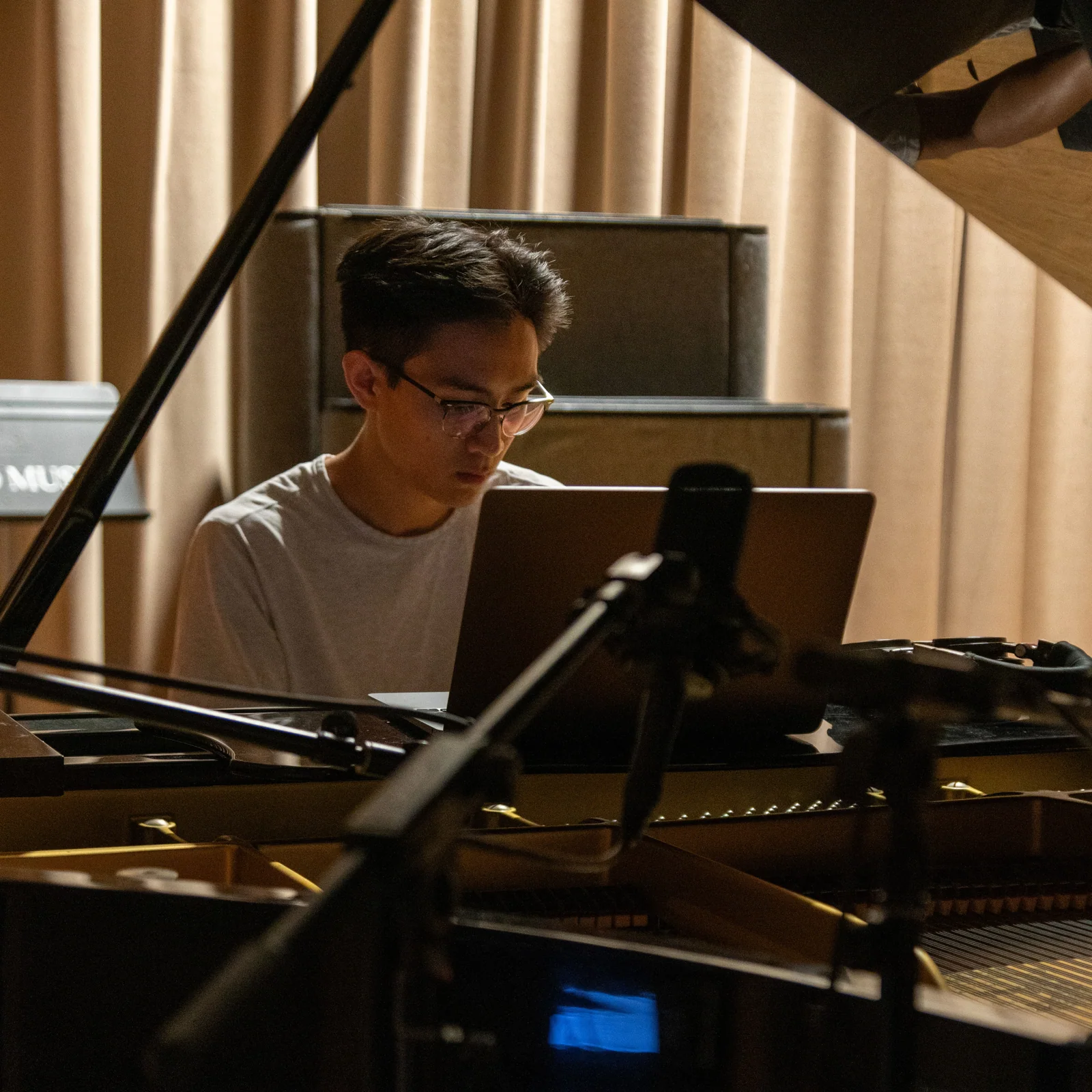 Larry at a grand piano in a recording session